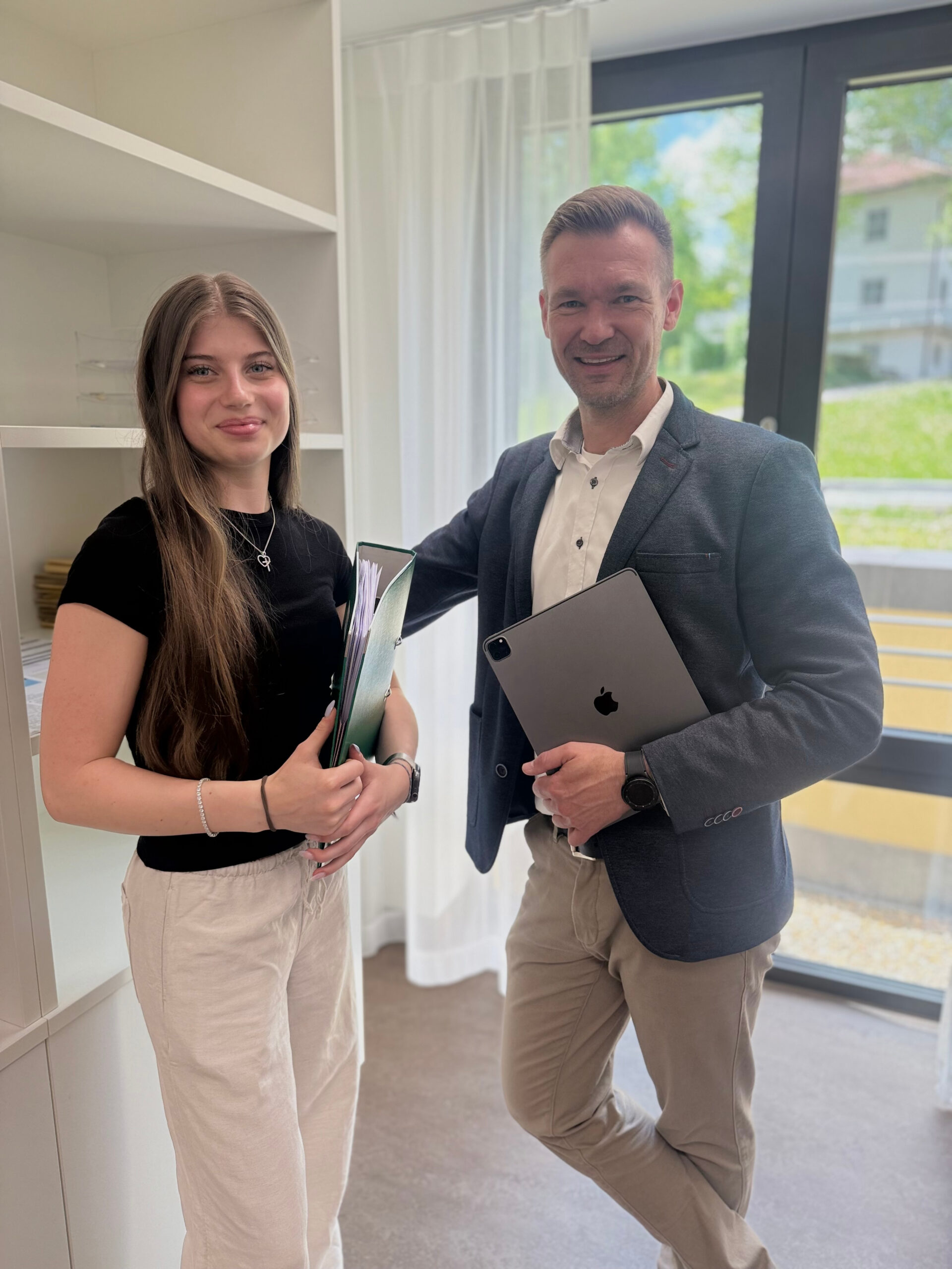 Foto von unserer Auszubildenden Kauffrau im Gesundheitswesen, Annika Ulrich, zusammen mit dem Leiter des Klinikcontrollings, Norman Daßler, im Büro vom Sommer 2025.